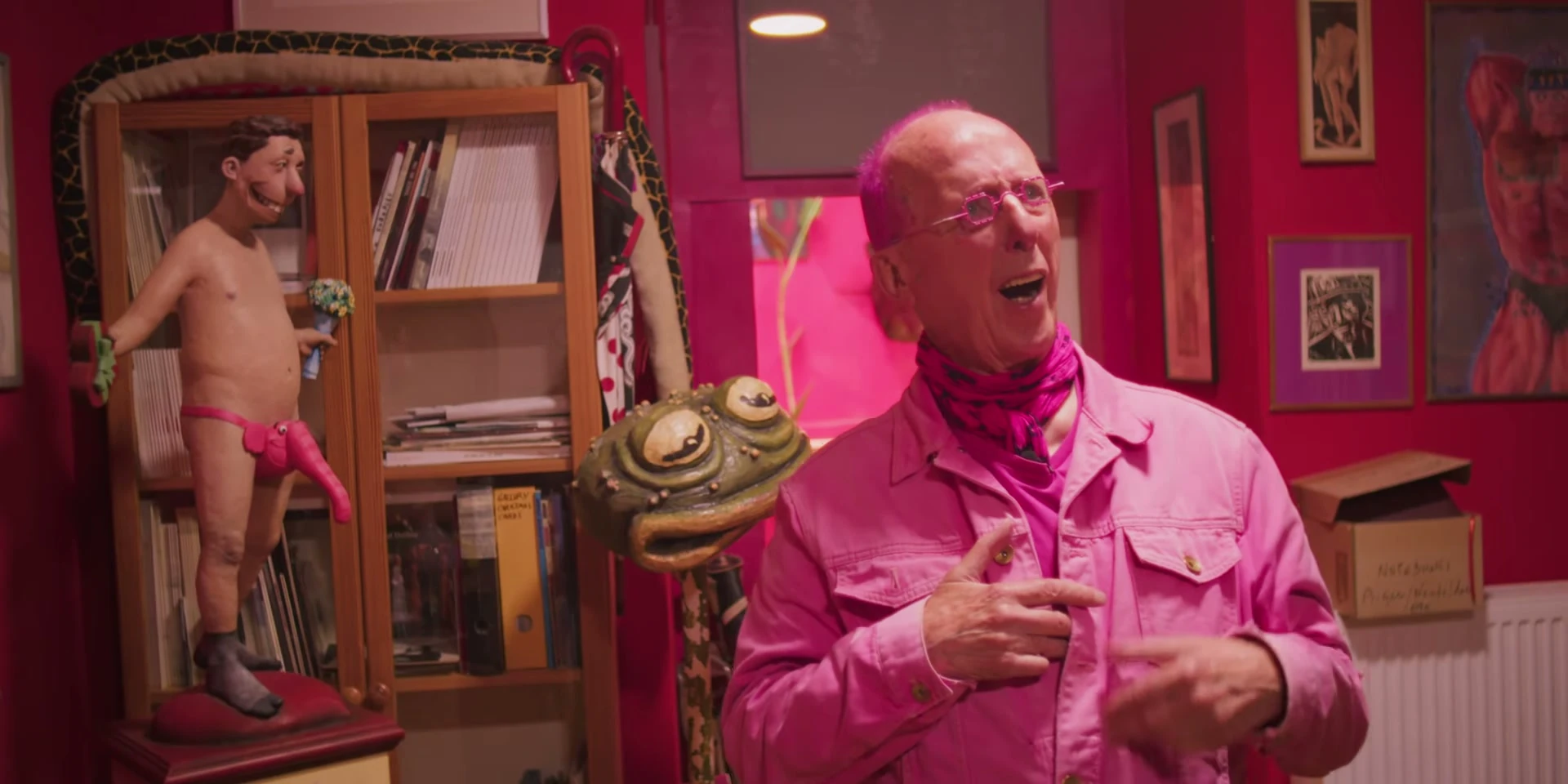 Nicholas Treadwell wearing pink in his art-filled room